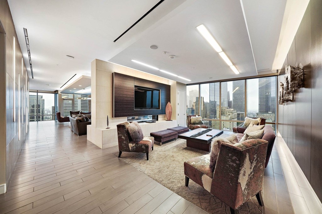 a large living room with a television and a large window