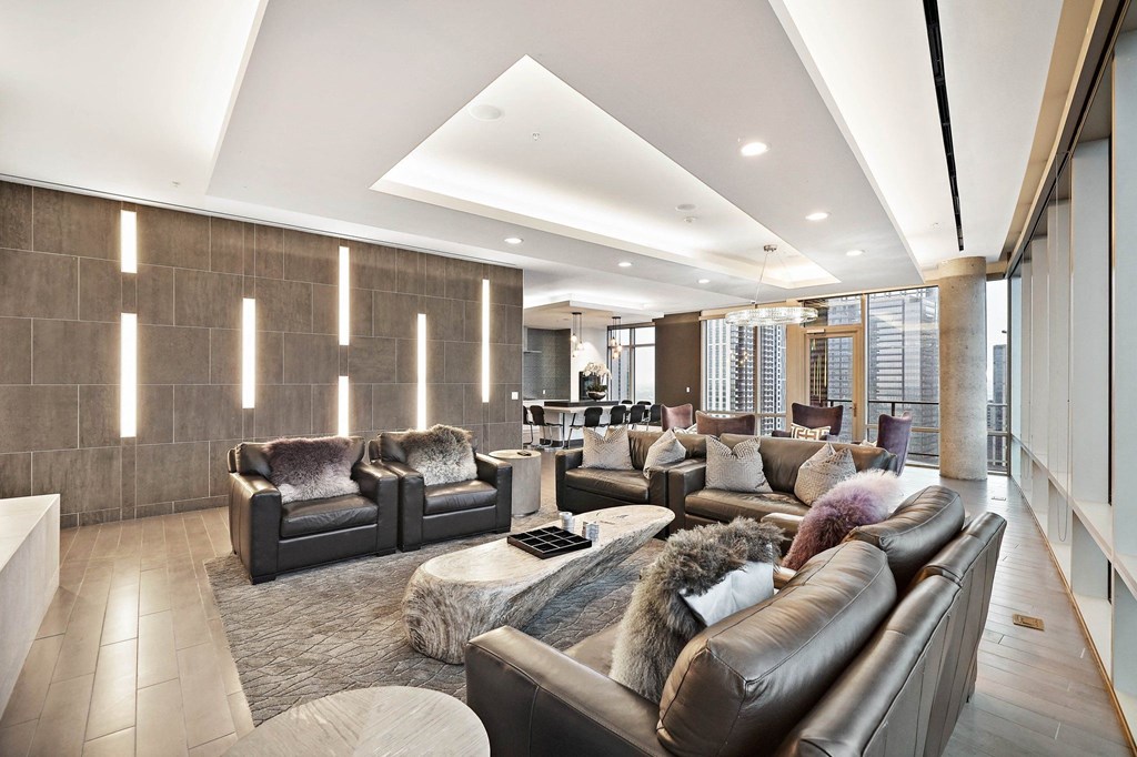 a large living room with couches and chairs and a rug