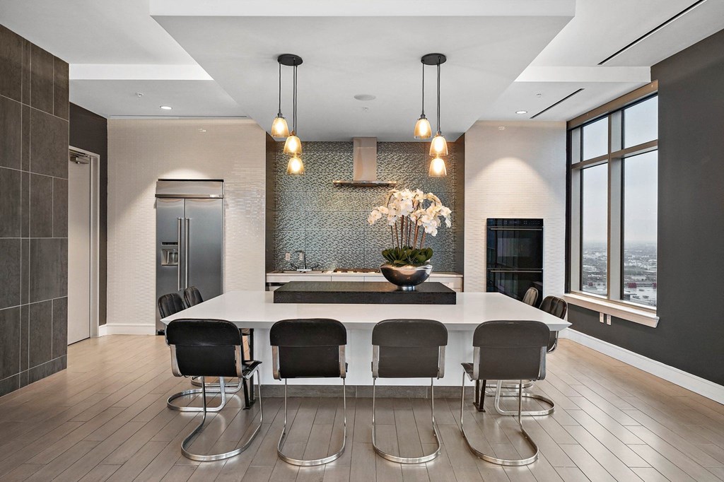a large kitchen with a large white island and chairs