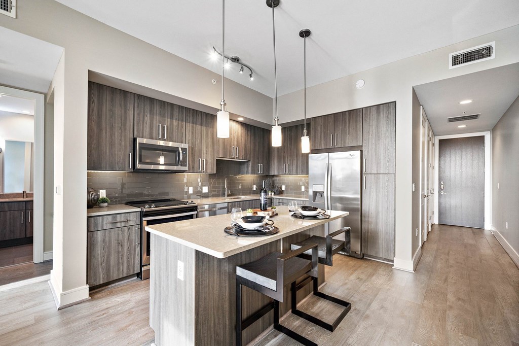 a kitchen with a large island with a table and chairs