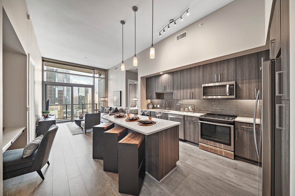 a kitchen and living room with a table and chairs