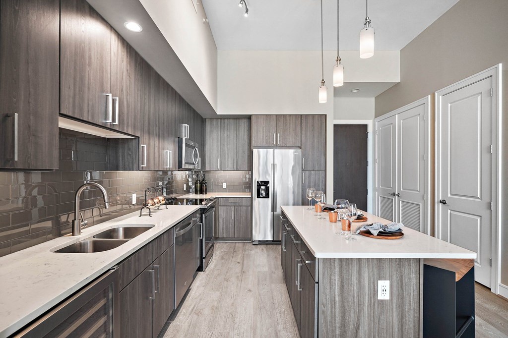 a kitchen with wooden cabinets and a white counter top