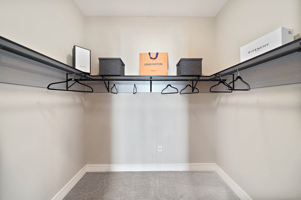a room with a shelf with speakers on it and a carpet