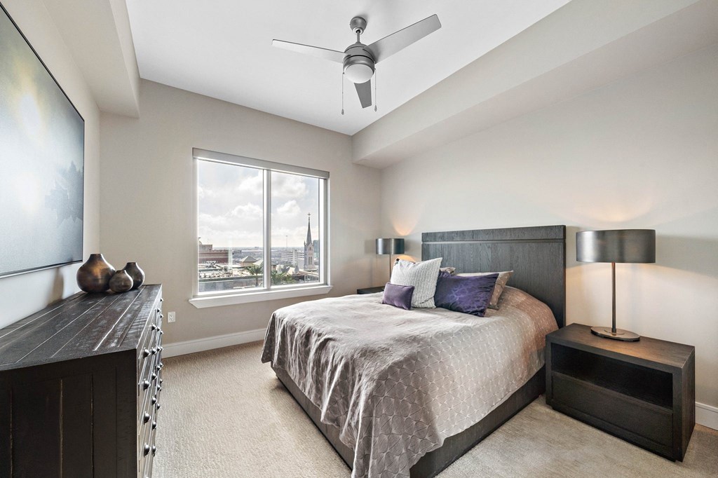 a bedroom with a large bed and a large window