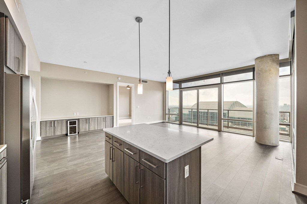 an open kitchen with a large island in the middle of it