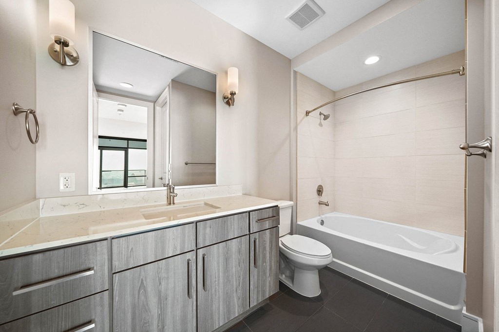 a bathroom with a sink toilet and a bath tub