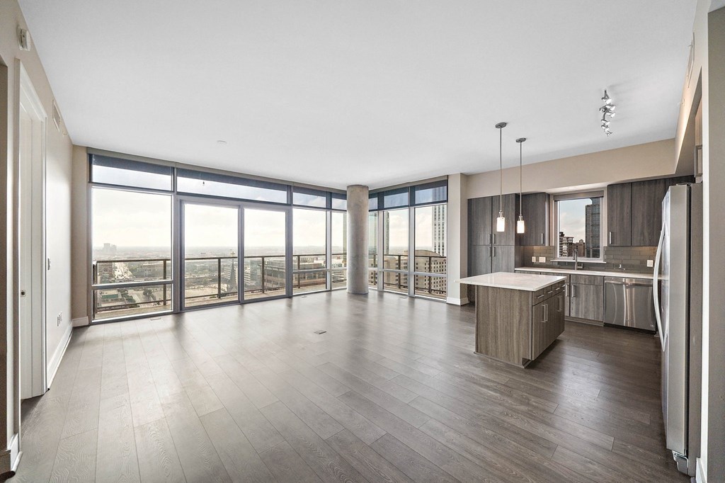 an open kitchen and living room with a view of the city