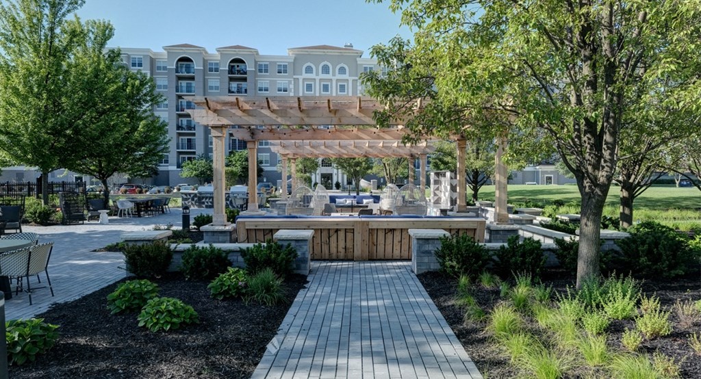 Walkway and garden leading to covered patio area at The Mil'Ton in Vernon Hills, IL