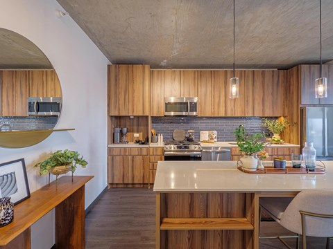 A modern kitchen with wooden cabinets and a large island.