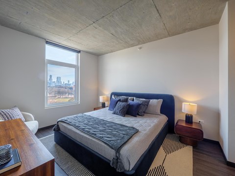 a bedroom with a bed and a large window