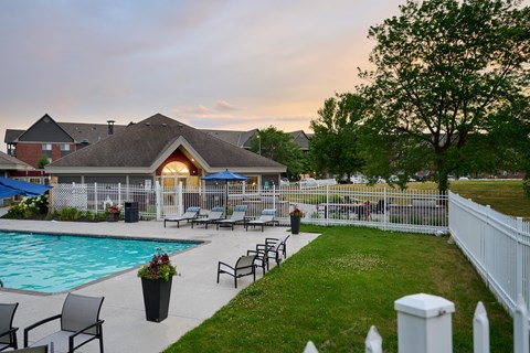 Valley Creek Apartments swimming pool surrounded by a sundeck and lawn