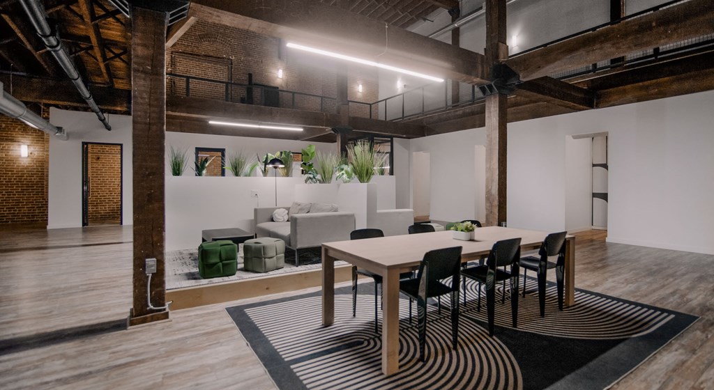A modern dining area with a wooden table and chairs.