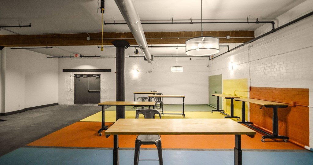 A room with a table and chairs in the center.