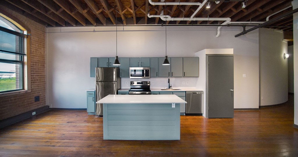 A kitchen with a blue island in the middle of the room.