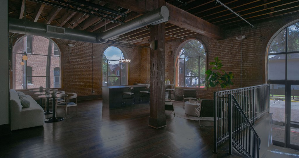 A large open space with a high ceiling and wooden floors.