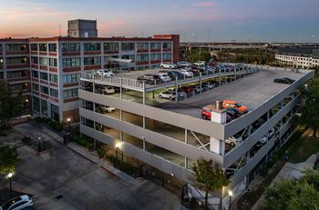 A parking garage with cars parked in it.