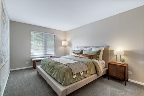 a bedroom with a large bed and a window