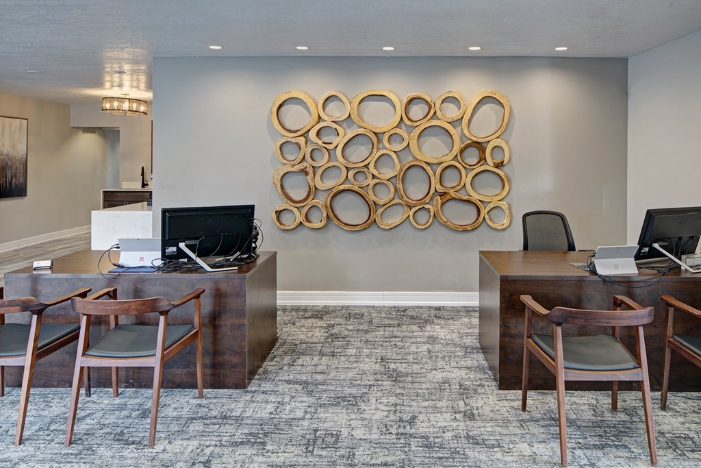 an office with desks and chairs and a bulletin board on the wall