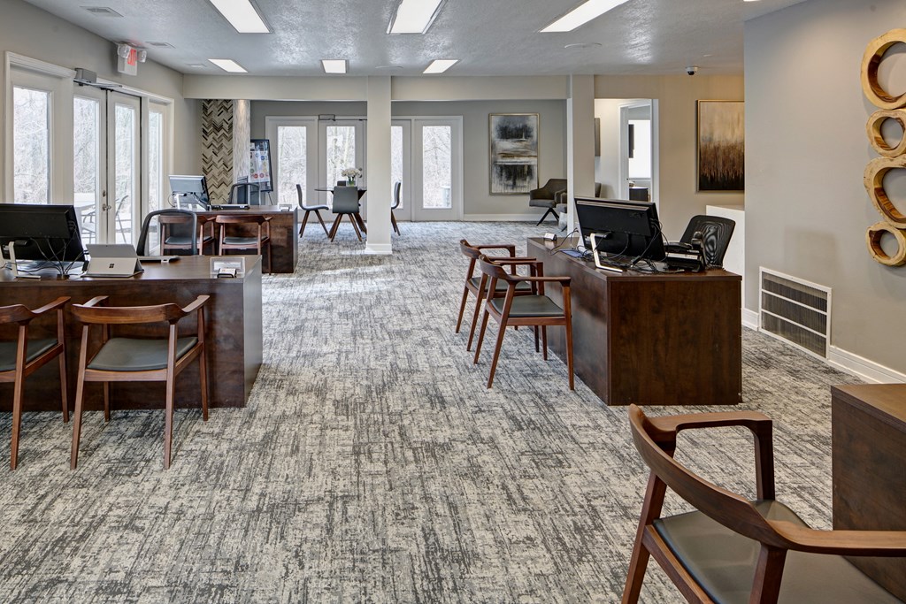 a large room with tables and chairs and computers