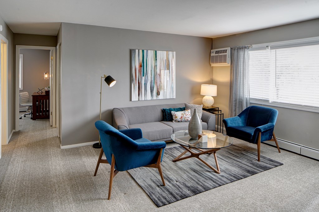 a living room with a couch and two chairs