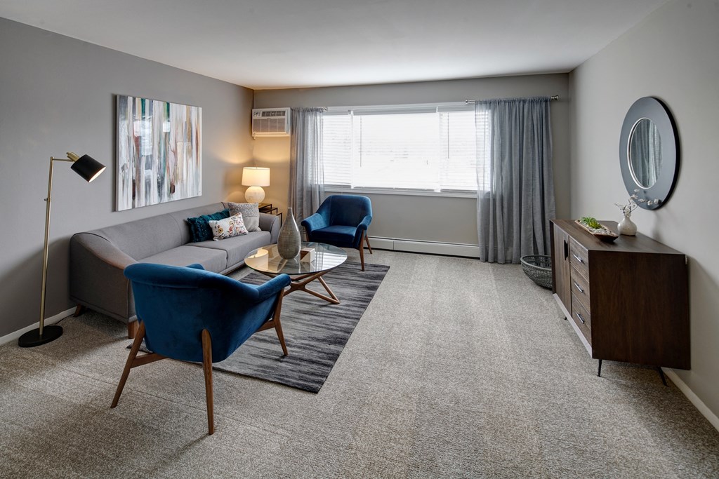 a living room with a couch and two chairs