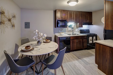 a kitchen and dining room with a small table and chairs
