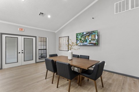 A dining room with a wooden table and chairs.
