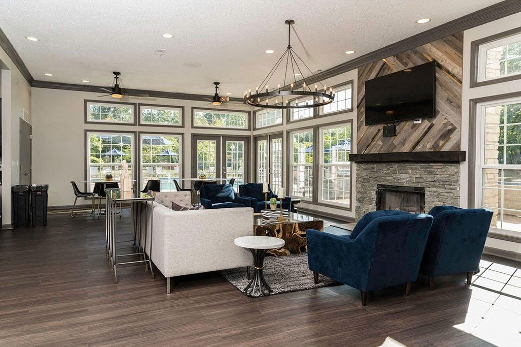seating area in front of a fireplace in the Fairlane Woods Apartments clubhouse