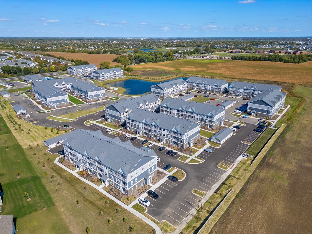 A large building complex with a parking lot in front.