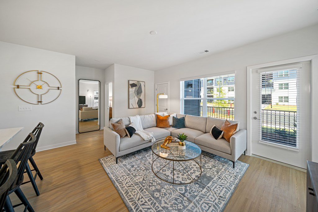A living room with a white couch and a coffee table.