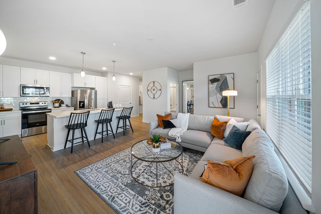 A modern living room with a grey sofa and a coffee table.