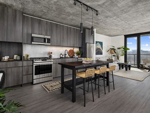 A modern kitchen with a dining table and chairs.