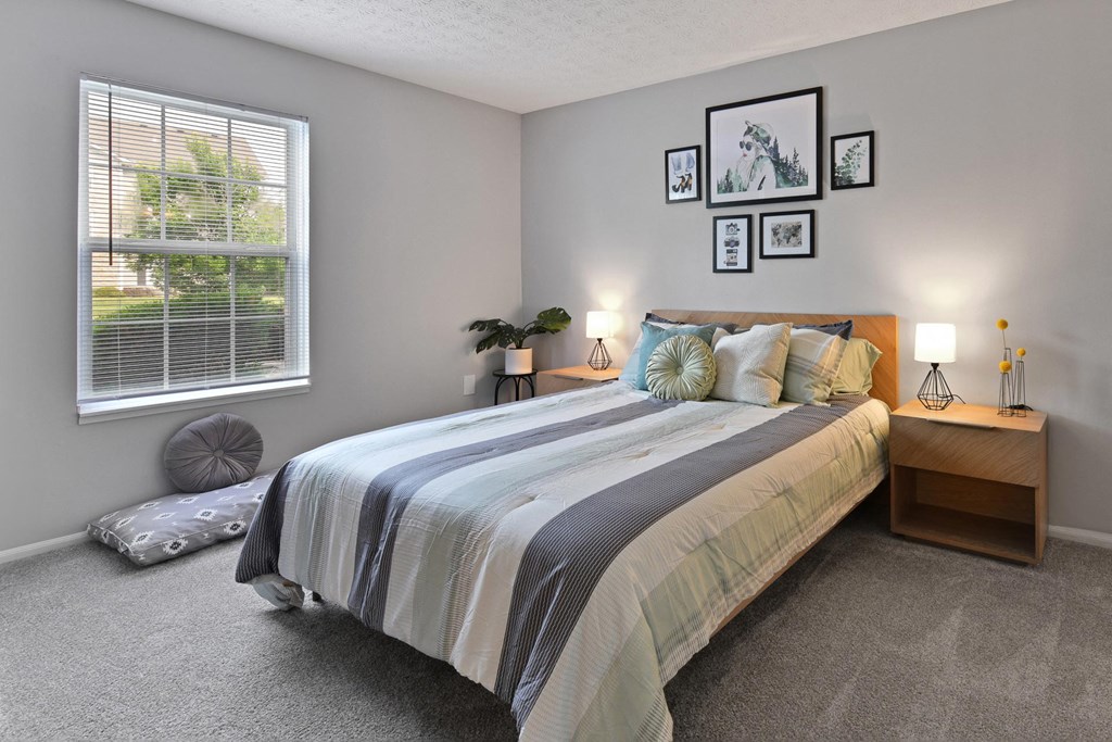 a bedroom with a bed and a window