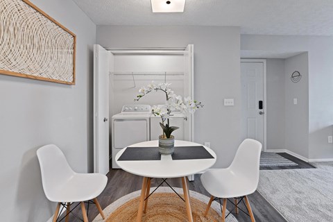 a dining room with a table and chairs and a laundry room