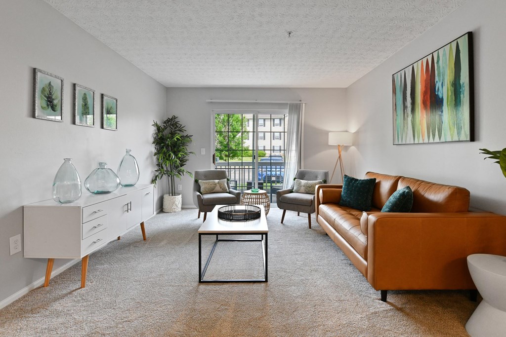 a living room with a leather couch and a table