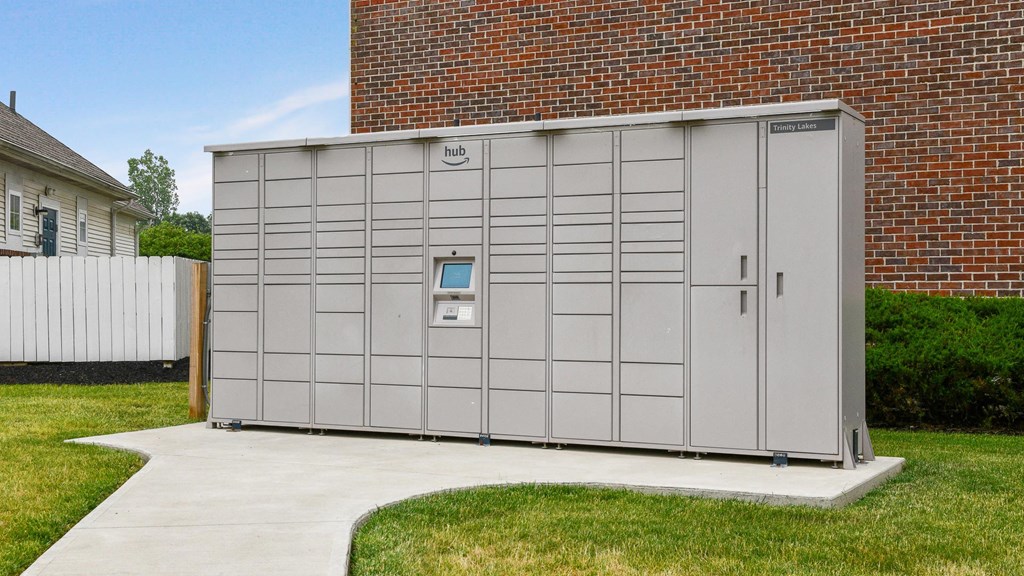 a small storage shed in front of a brick building