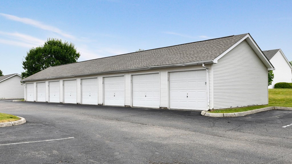 a white garage with white doors on the side of a building