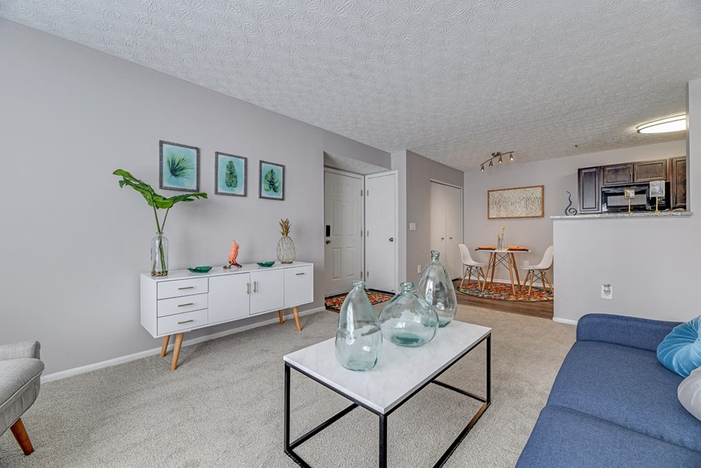 a living room with a blue couch and a white table