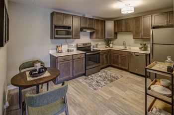 apartment kitchen with wooden cabinets and stainless steel appliances