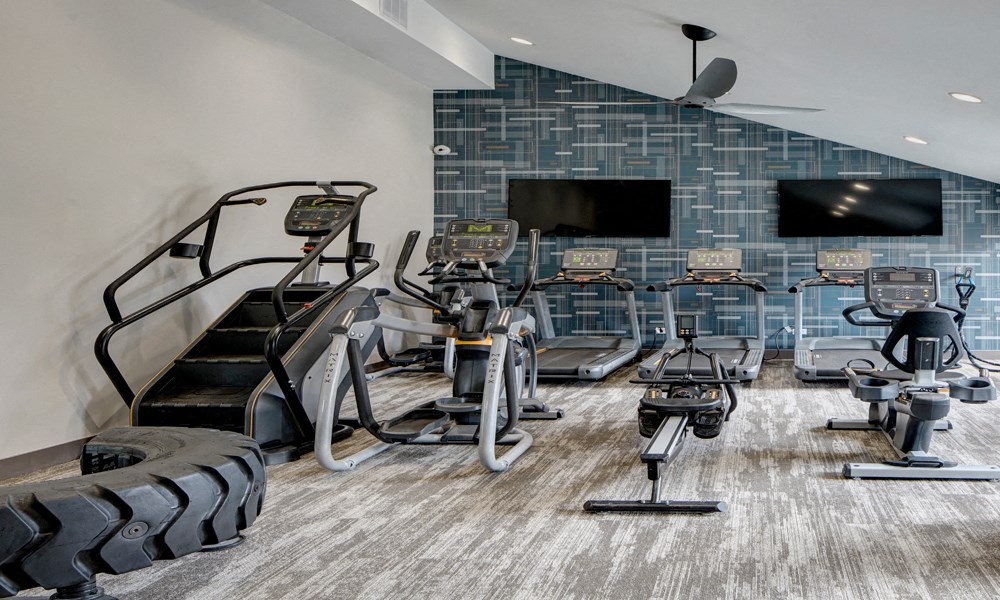 multiple cardio machines in the Willow Crossing Apartments fitness center