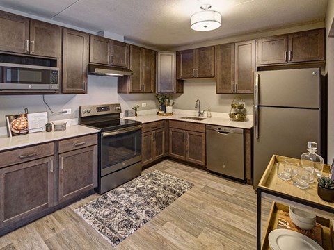 a kitchen with stainless steel appliances and wooden cabinets