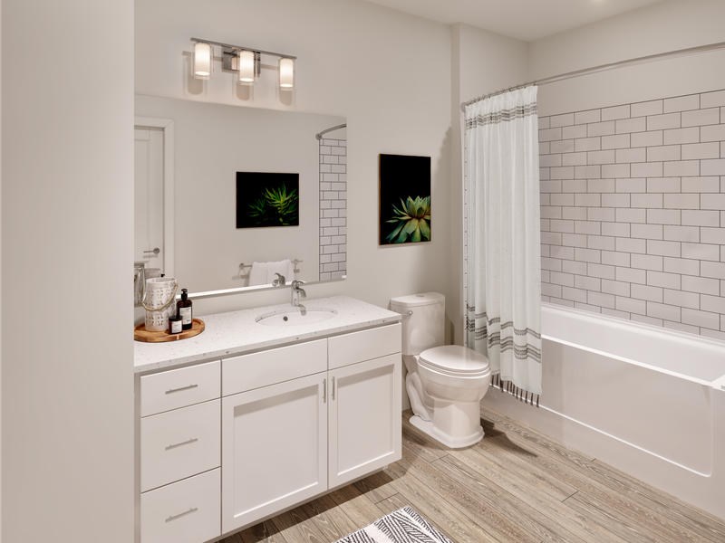 A white bathroom with a toilet, sink, and bathtub.