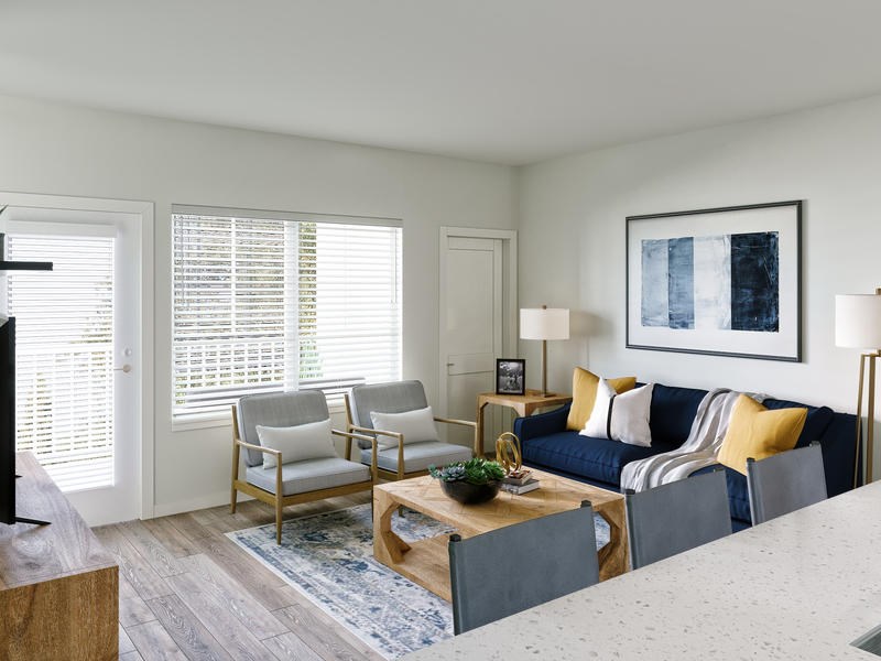 A living room with a blue couch and a coffee table.