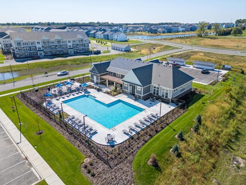 A large swimming pool with a building next to it.