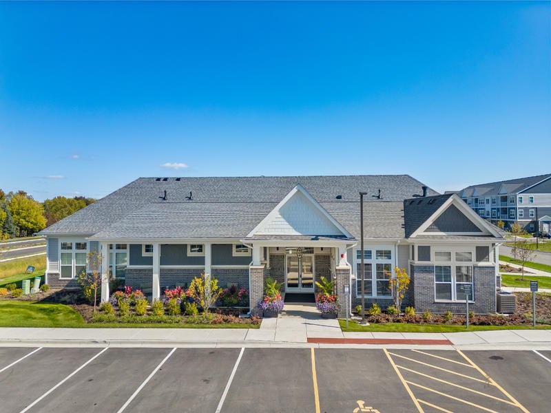 A building with a parking lot in front of it.