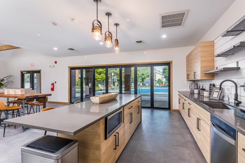 A modern kitchen with wooden cabinets and stainless steel appliances.