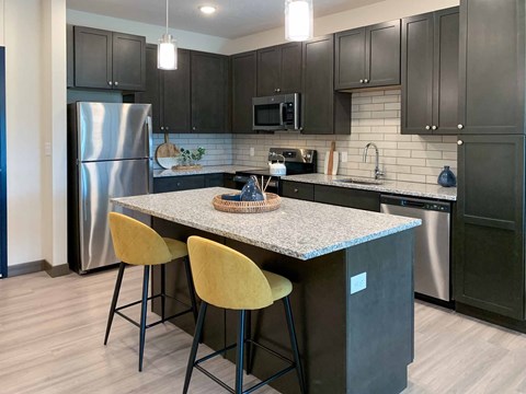a kitchen with stainless steel appliances and a counter top