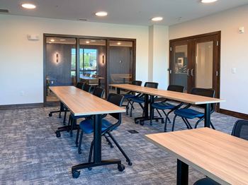 A large conference room with tables and chairs