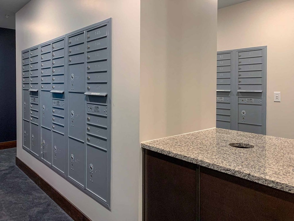 A mail room with resident mailboxes and package lockers