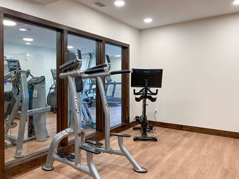 A spin studio with a window to the main gym